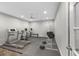 A complete home gym features a treadmill, weights, ceiling fan and gray rubber flooring at 6454 Meridian Way, Atlanta, GA 30328