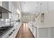 Bright, open kitchen with stainless steel appliances, white cabinetry, and an eat-in island at 6454 Meridian Way, Atlanta, GA 30328