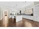 Large, modern kitchen featuring white cabinets, a central island, and hardwood floors at 6454 Meridian Way, Atlanta, GA 30328