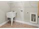 Functional laundry area featuring a utility sink and convenient hook ups, perfect for tackling household chores with ease at 6454 Meridian Way, Atlanta, GA 30328