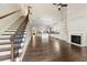 Open-concept living area with a fireplace, hardwood floors, and a view of the kitchen at 6454 Meridian Way, Atlanta, GA 30328