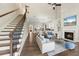 Open-concept living room featuring a fireplace, hardwood floors, and seamless flow to the modern kitchen at 6454 Meridian Way, Atlanta, GA 30328