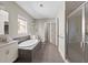 Modern main bathroom featuring a soaking tub, glass-enclosed shower, and elegant tile flooring at 6454 Meridian Way, Atlanta, GA 30328