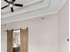 Spacious primary bedroom with tray ceiling, fan, and barn doors that allow a peek into the bathroom at 6454 Meridian Way, Atlanta, GA 30328