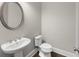 Tastefully decorated powder room with a pedestal sink, modern fixtures, and neutral wall paint at 6454 Meridian Way, Atlanta, GA 30328