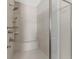 Modern walk-in shower with sleek tile, a built-in seat, and a multi-setting shower head at 6454 Meridian Way, Atlanta, GA 30328