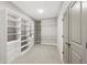 Spacious walk-in closet with custom built-in shelving and ample storage space, offering convenient organization solutions at 6454 Meridian Way, Atlanta, GA 30328
