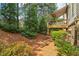 Back yard featuring back deck with awning, complemented by lush landscaping, lawn, and natural setting at 823 Canterbury Overlook, Atlanta, GA 30324