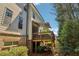 Exterior view of back deck with retractable awning, wooden railing, and brick foundation at 823 Canterbury Overlook, Atlanta, GA 30324