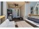 Relaxing covered back porch with neutral-colored furniture, ceiling fan, and outdoor space at 823 Canterbury Overlook, Atlanta, GA 30324