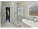 Bright bathroom featuring a glass shower, freestanding tub, and white tile floors at 823 Canterbury Overlook, Atlanta, GA 30324
