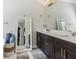 Bathroom with double vanity, dark wood cabinets, marble countertops, and neutral walls at 823 Canterbury Overlook, Atlanta, GA 30324