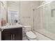 Clean, efficient bathroom with a dark wood vanity, white sink, shower with glass doors, and modern fixtures at 823 Canterbury Overlook, Atlanta, GA 30324
