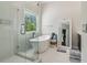 Bathroom features a glass shower, freestanding tub, large mirror, and white tile floors at 823 Canterbury Overlook, Atlanta, GA 30324