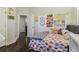 Inviting bedroom with hardwood floors, comfortable bed, and unique decor with an open door to the hallway at 823 Canterbury Overlook, Atlanta, GA 30324