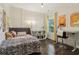 Bright bedroom featuring hardwood floors, a comfortable bed, ample lighting and workspace perfect for studying and relaxation at 823 Canterbury Overlook, Atlanta, GA 30324