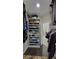 View of organized walk-in closet with built-in shelving, drawers, and hardwood floors at 823 Canterbury Overlook, Atlanta, GA 30324