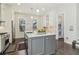 Bright kitchen features a center island with white countertop, stainless steel appliances, and hardwood floors at 823 Canterbury Overlook, Atlanta, GA 30324
