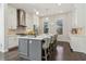 Modern kitchen with white cabinets, gray island with seating, stainless steel appliances and hardwood floors at 823 Canterbury Overlook, Atlanta, GA 30324