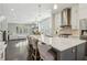 Open concept kitchen featuring a large center island with pendant lighting, stainless steel appliances, and hardwood floors at 823 Canterbury Overlook, Atlanta, GA 30324