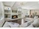 Open-concept living room with hardwood floors, modern fireplace and view of the adjoining kitchen and dining area at 823 Canterbury Overlook, Atlanta, GA 30324