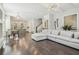 Open-concept living room with hardwood floors, adjoining the dining area and a view of the stairs at 823 Canterbury Overlook, Atlanta, GA 30324