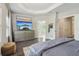 Bright main bedroom with hardwood floors, tray ceilings, large windows, and a doorway to the bathroom at 823 Canterbury Overlook, Atlanta, GA 30324