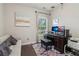 Comfortable office space with ample natural light, dark wood floors, and a comfortable sofa for relaxation at 823 Canterbury Overlook, Atlanta, GA 30324