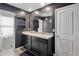 Bathroom with dual sinks, granite countertops and dark wood cabinets at 1439 Veranda Ln, Mcdonough, GA 30253