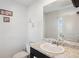 Comfortable half bathroom with granite vanity and decorative wall art at 1439 Veranda Ln, Mcdonough, GA 30253