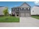 Charming two-story home featuring a two-car garage, well-maintained lawn, and neutral exterior at 1439 Veranda Ln, Mcdonough, GA 30253