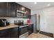 Galley kitchen featuring granite countertops, stainless steel appliances and dark wood cabinets at 1439 Veranda Ln, Mcdonough, GA 30253