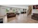 Open living room featuring hardwood floors adjacent to the kitchen and stairwell at 1439 Veranda Ln, Mcdonough, GA 30253