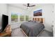 Comfortable bedroom featuring a ceiling fan, soft carpet, and bright windows for natural lighting at 4068 Allegretto Se Cir # 10, Atlanta, GA 30339