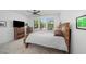 Cozy bedroom featuring a rustic wood bed frame, and bright window at 4068 Allegretto Se Cir # 10, Atlanta, GA 30339