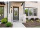 Inviting front entrance with stylish door, manicured landscaping, and brick accents at 4068 Allegretto Se Cir # 10, Atlanta, GA 30339