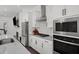 This bright modern kitchen features white cabinets and stainless appliances and view into living area at 4068 Allegretto Se Cir # 10, Atlanta, GA 30339