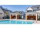 Inviting community pool area featuring lounge chairs, shaded gazebos, and nearby residential buildings at 4068 Allegretto Se Cir # 10, Atlanta, GA 30339