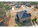 Beautiful aerial view of a brick house with a large well-maintained lawn and many trees at 4580 Cloister Cir, Hampton, GA 30228