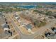 Beautiful aerial view of homes in a lakeside community featuring manicured lawns, mature trees, and lake views at 4580 Cloister Cir, Hampton, GA 30228