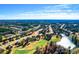 Expansive aerial view showcasing the community's golf course, ponds, and residential area at 4580 Cloister Cir, Hampton, GA 30228