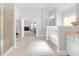 Well-lit bathroom with a tub, glass shower, and access to the main bedroom at 4580 Cloister Cir, Hampton, GA 30228