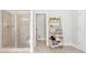 Bright bathroom with a glass-enclosed shower and stylish towel storage at 4580 Cloister Cir, Hampton, GA 30228