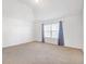 Bright bedroom with large window and neutral carpet under a vaulted ceiling at 4580 Cloister Cir, Hampton, GA 30228