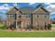 Beautiful brick home with a manicured lawn, mature trees and blue sky at 4580 Cloister Cir, Hampton, GA 30228