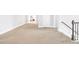 Beige carpeted hallway with white trim and staircase at 4580 Cloister Cir, Hampton, GA 30228