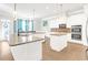Bright kitchen boasts white cabinets, granite countertops, stainless steel appliances, and hardwood floors at 4580 Cloister Cir, Hampton, GA 30228