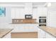Stylish kitchen with white cabinets, stainless appliances and granite countertops at 4580 Cloister Cir, Hampton, GA 30228