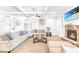 Spacious living room features a stone fireplace, coffered ceilings, and a comfortable sectional sofa at 4580 Cloister Cir, Hampton, GA 30228