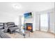 Inviting living room with a cozy fireplace, large-screen TV, and comfortable seating at 4580 Cloister Cir, Hampton, GA 30228